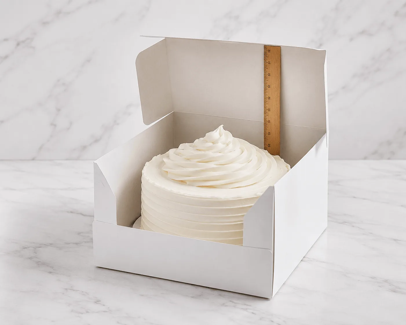 Side-by-side comparison of cake box depth options from 4-inch to 12-inch showing different cake builds inside each box